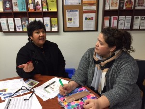 Esther Rosario, an independent consultant for the Orland schools,, discusses the immigration fair with Neli Pe�a of Orland Unified.